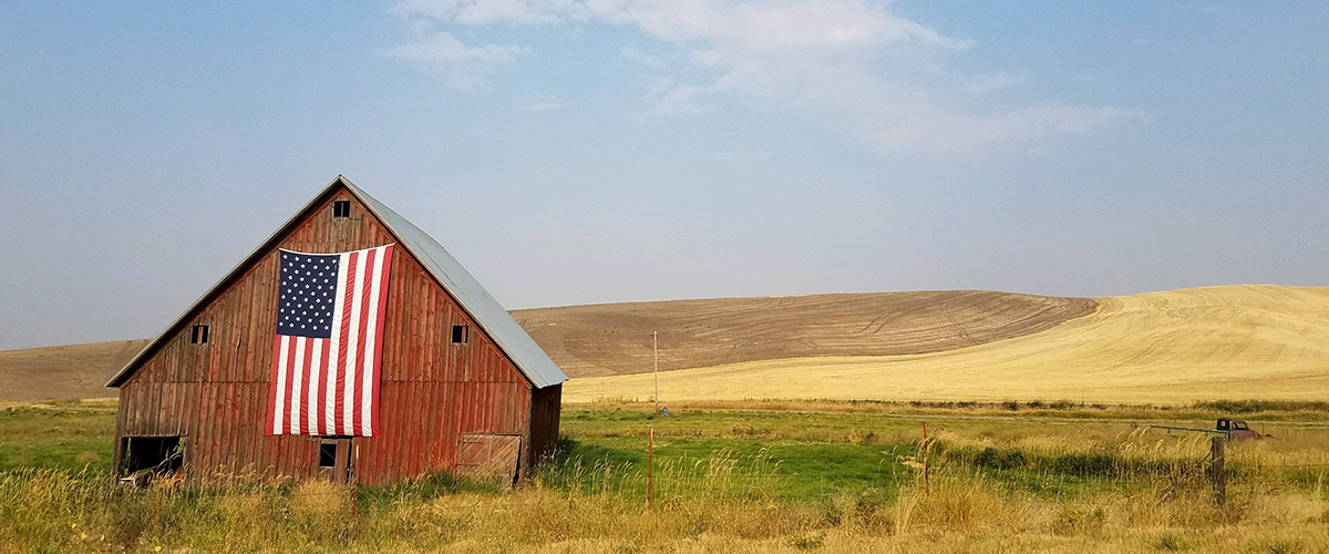 Barn with a flag in a field